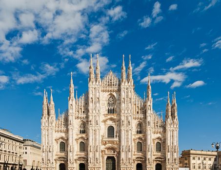 Stunning view of the Duomo di Milano with its intricate architecture against a bright blue sky.