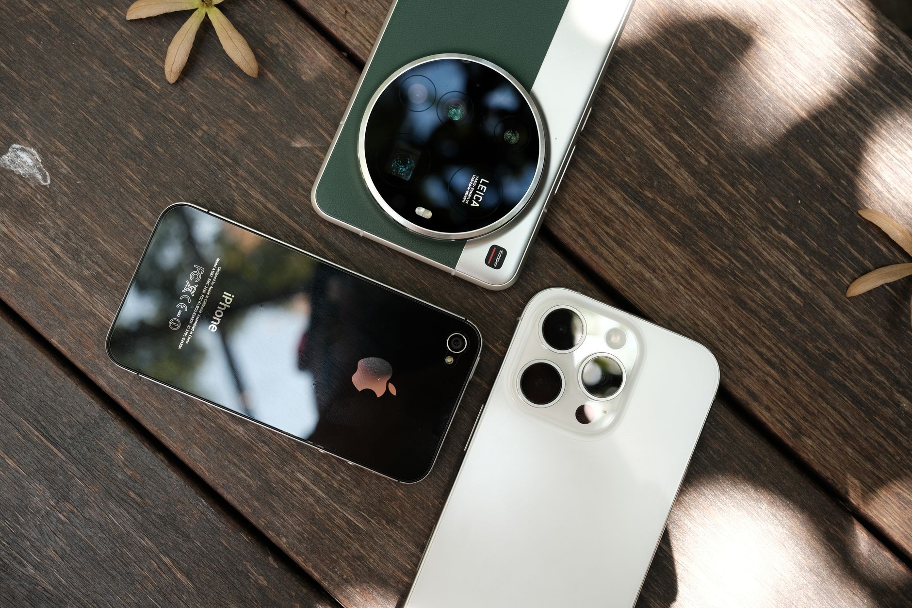 Overhead composition of multiple smartphones on a wooden surface, highlighting contemporary technology.