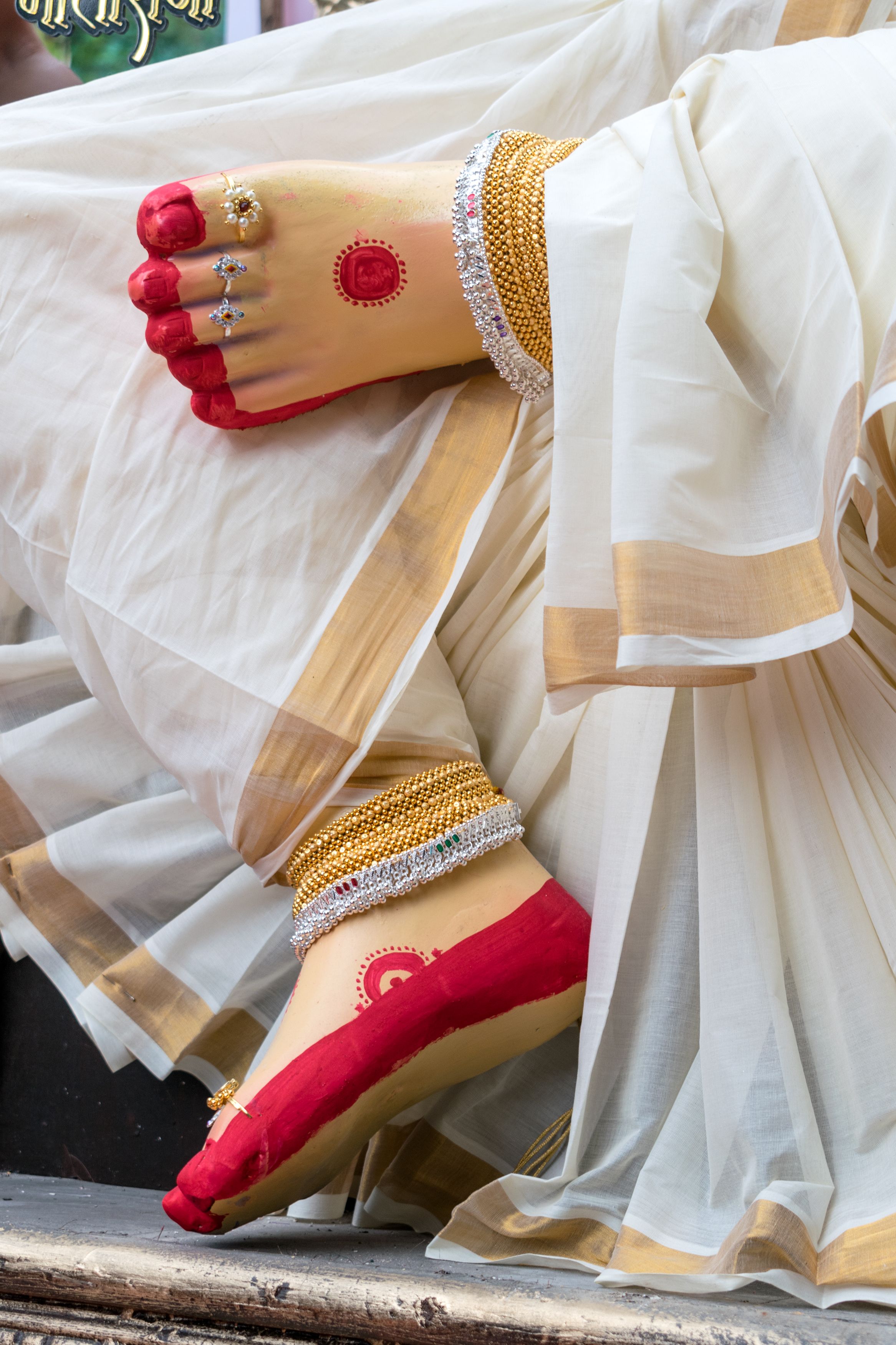 Close-up of traditional Indian festive footwear with anklets worn during cultural celebrations.
