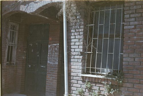 Free Old brick building facade with iron bars and ivy in Istanbul, capturing urban decay. Stock Photo