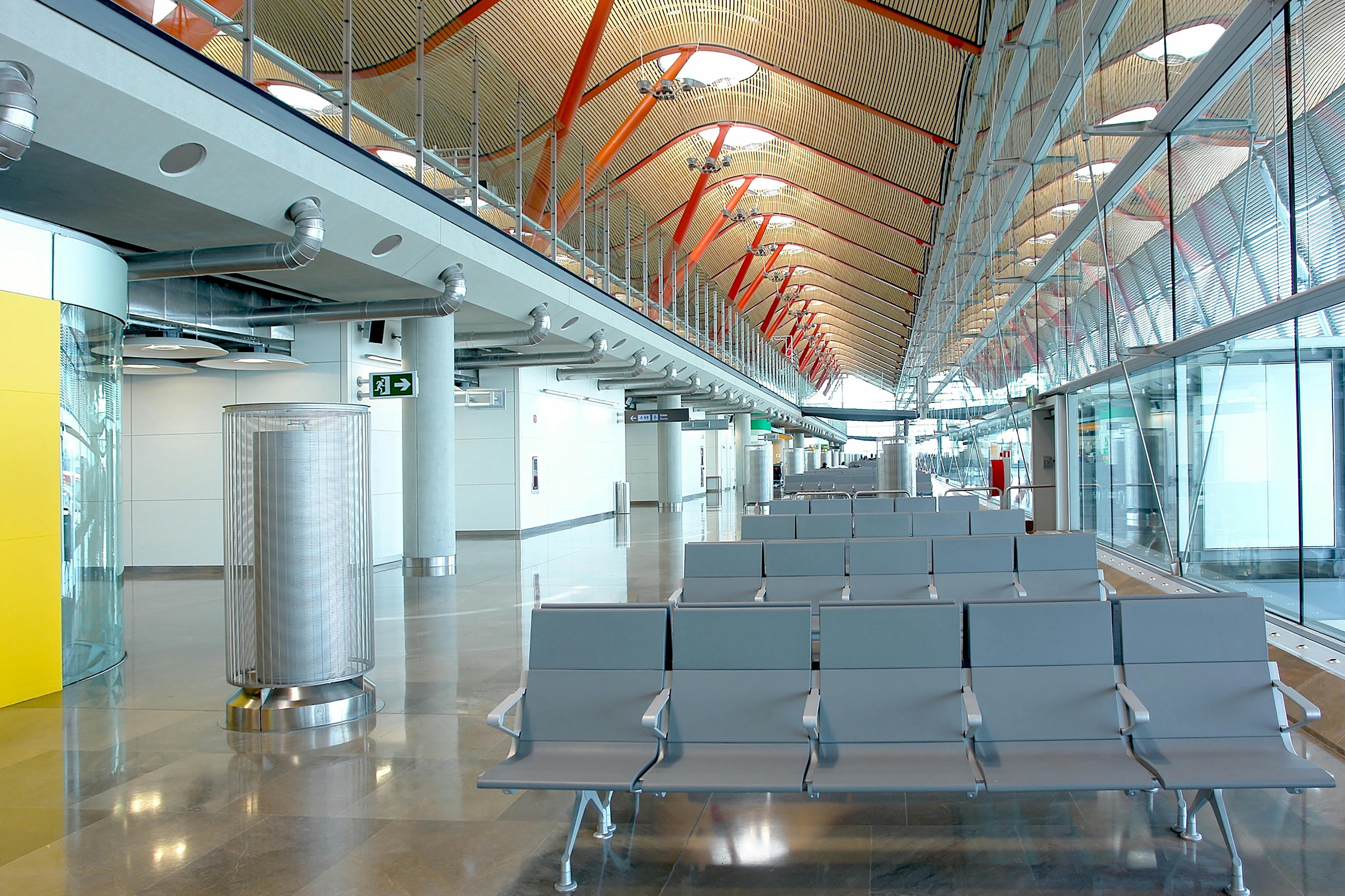 smiling family with a four-year-old girl walking in the departure terminal