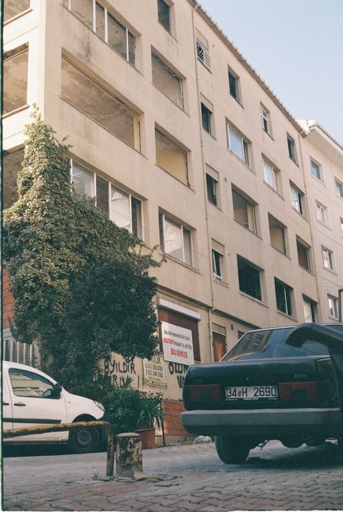 Free Street view of residential buildings and parked cars in an Istanbul neighborhood. Stock Photo