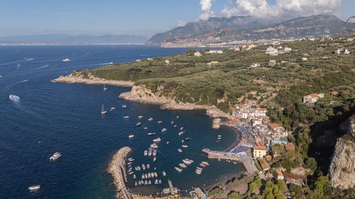 Free Stunning aerial view of the Amalfi coastline with boats and lush greenery, Italy. Stock Photo