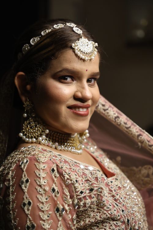 Free Close-up of an Indian bride in traditional attire with intricate jewelry, exuding elegance and joy. Stock Photo