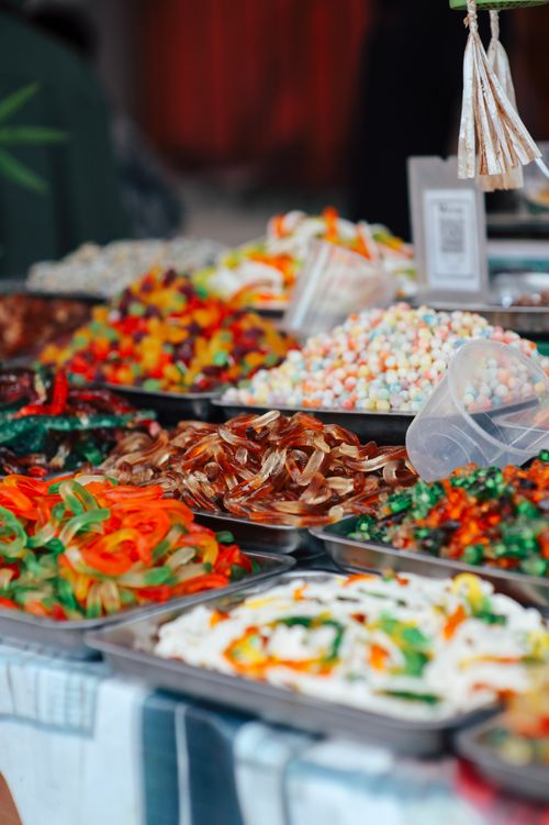 Free Colorful assortment of candies on display at a lively market stall, offering a sweet temptation. Stock Photo