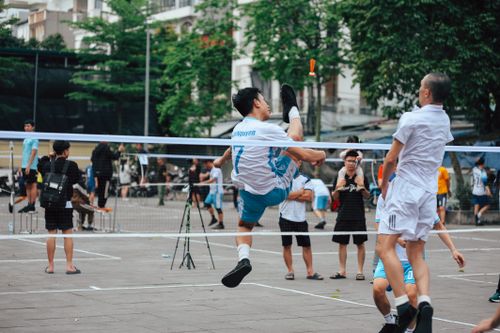 Free Action-packed sepak takraw match with skillful players in an outdoor urban area. Stock Photo