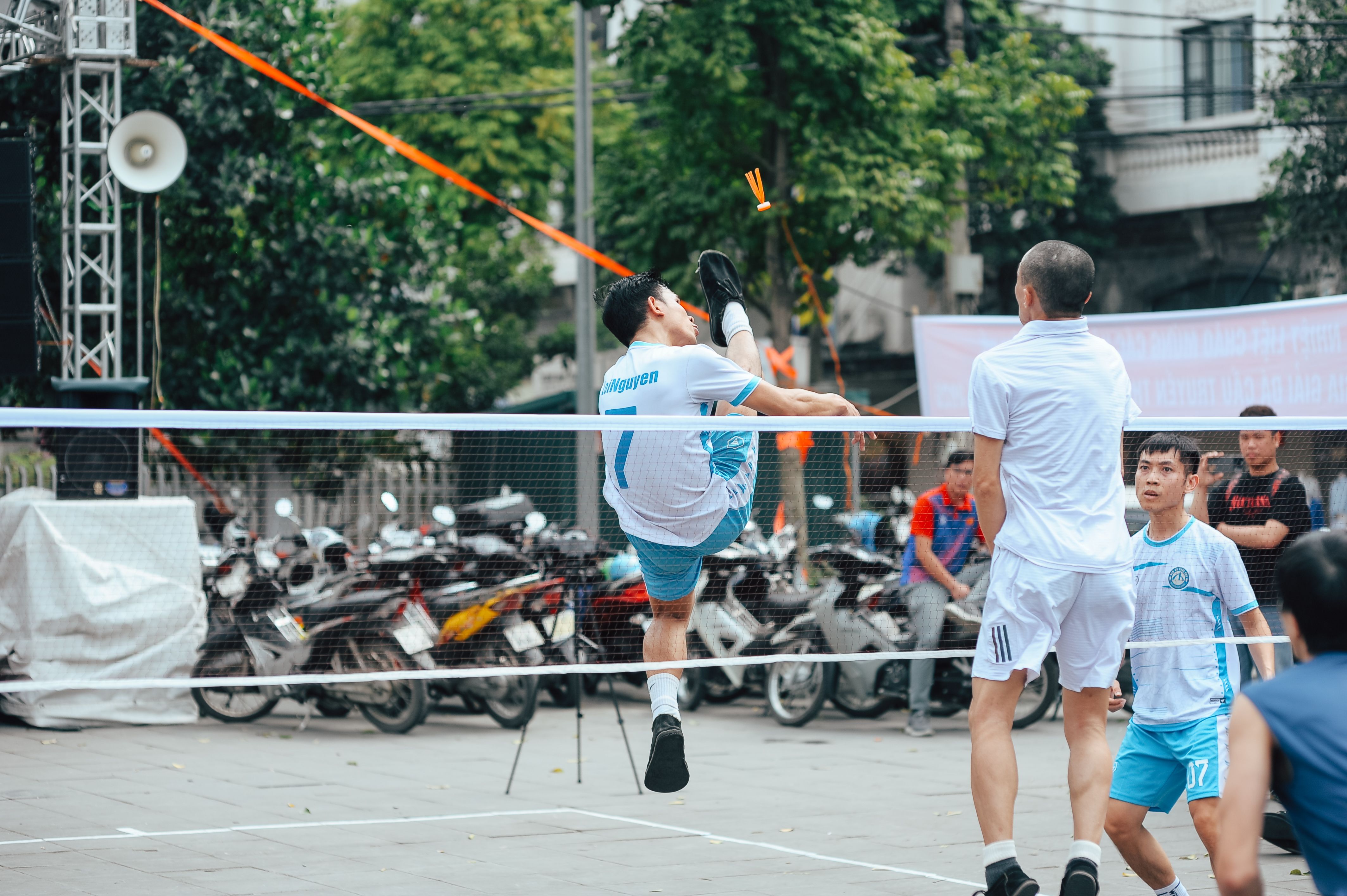 Athletes showcasing skills in an exciting outdoor Sepak Takraw match.