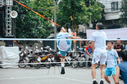 Athletes showcasing skills in an exciting outdoor Sepak Takraw match.