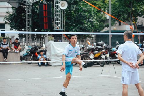 Free Action-packed scene of a Sepak Takraw match with two adults playing intensely outdoors. Stock Photo
