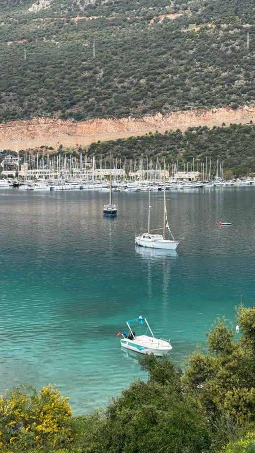 Free Serene view of yachts and sailboats on turquoise waters in a Mediterranean harbor. Stock Photo