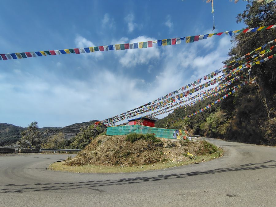 Mountain road with colourful flags in Uttarakhand