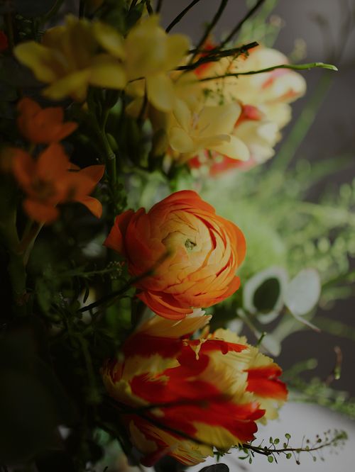 Free Bright and colorful floral bouquet featuring vivid ranunculus and lush greenery, perfect for spring decor. Stock Photo