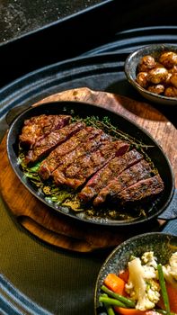 Deliciously grilled steak served with crispy potatoes and seasonal vegetables.