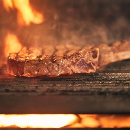 Meat on the grill among the flames