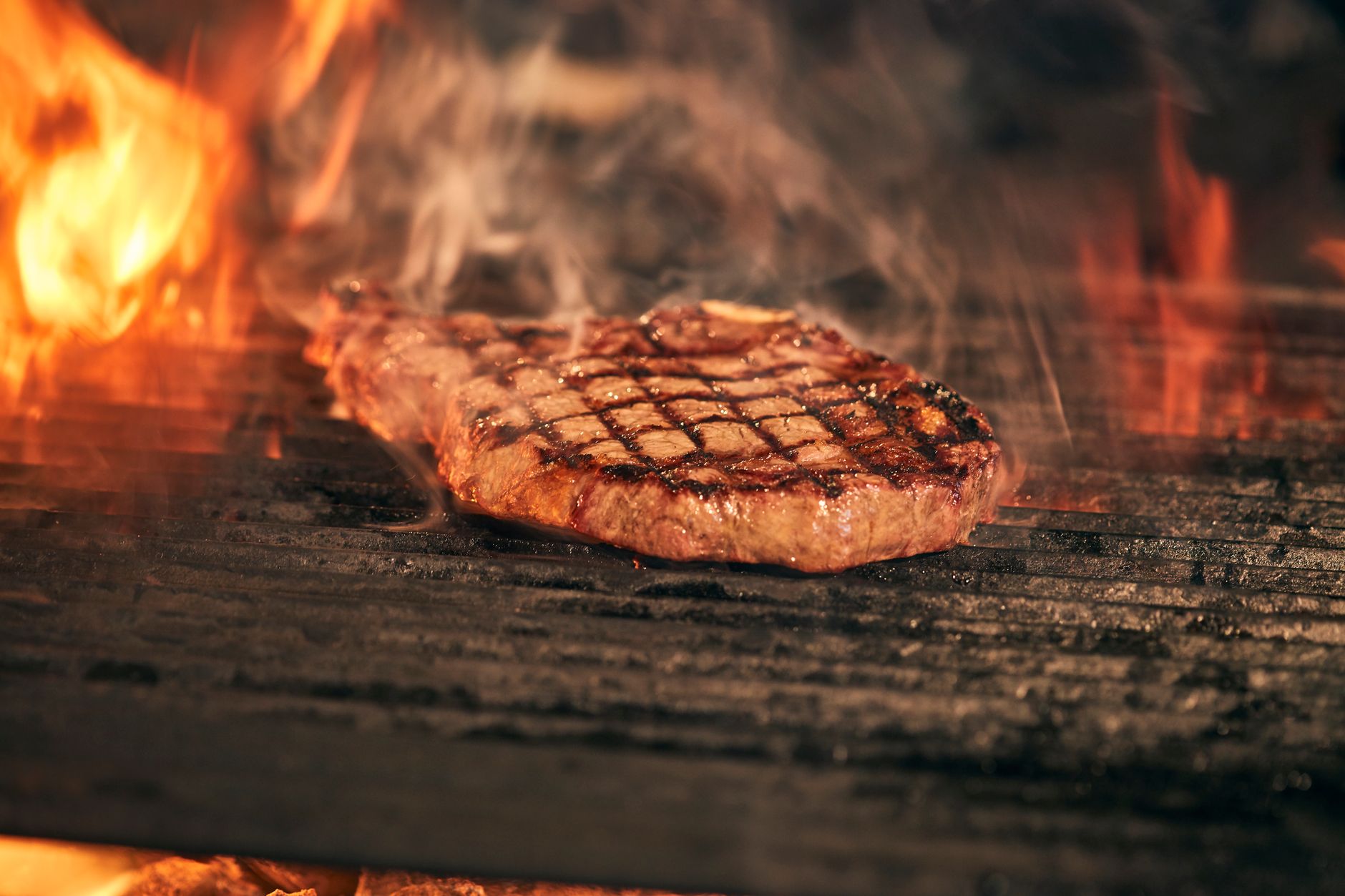 Fire-grilled T-Bone steak with seasoning and garnishes