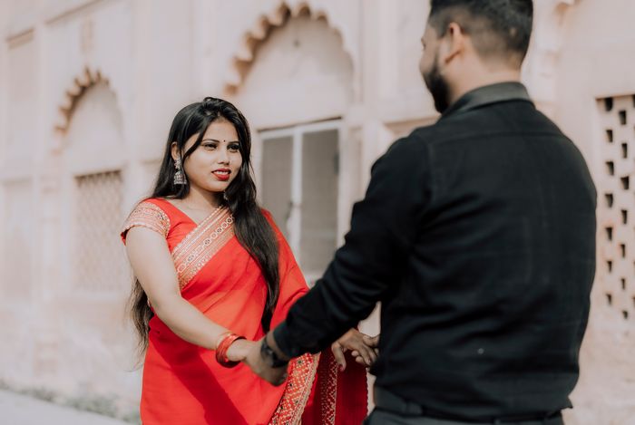 Indian couple in traditional attire holding hands