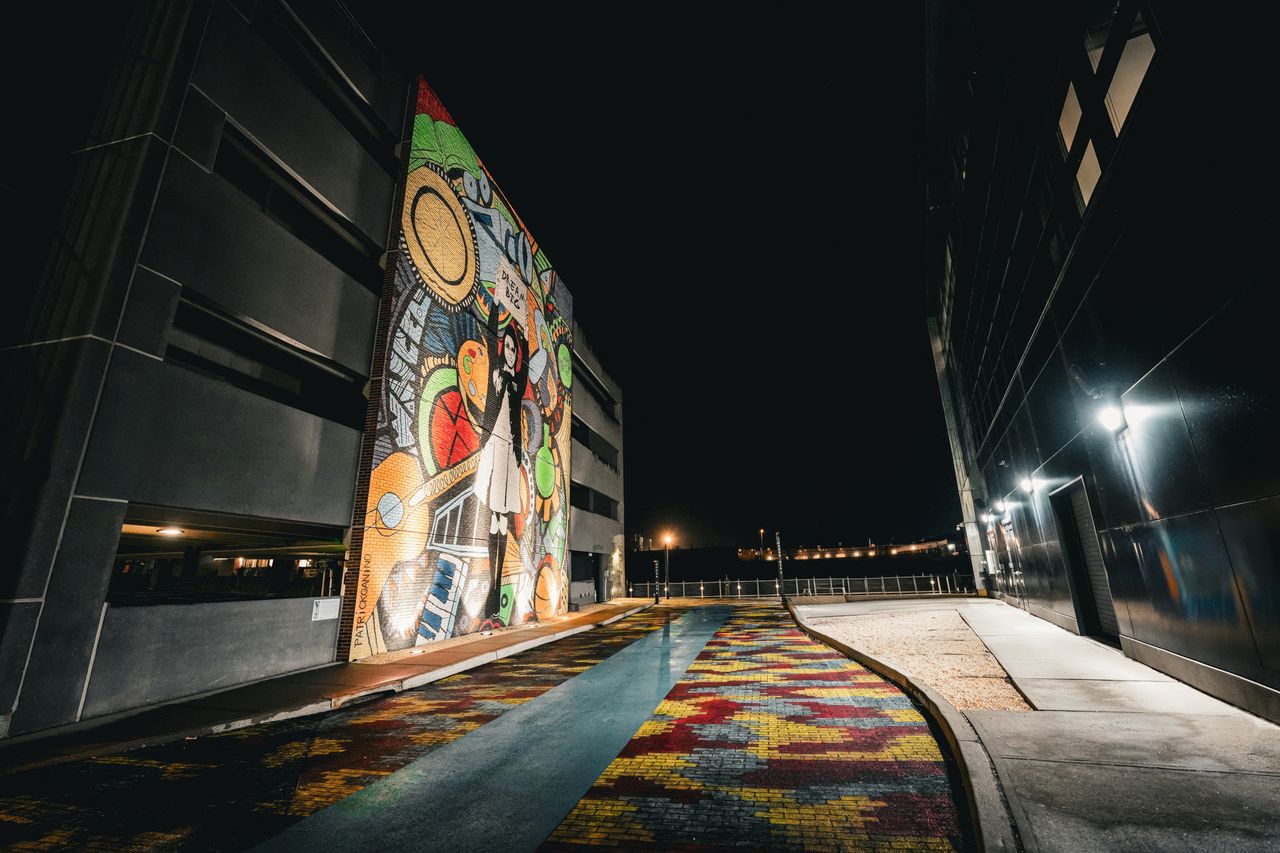 vibrant street mural illuminated at night showcasing an artistic urban