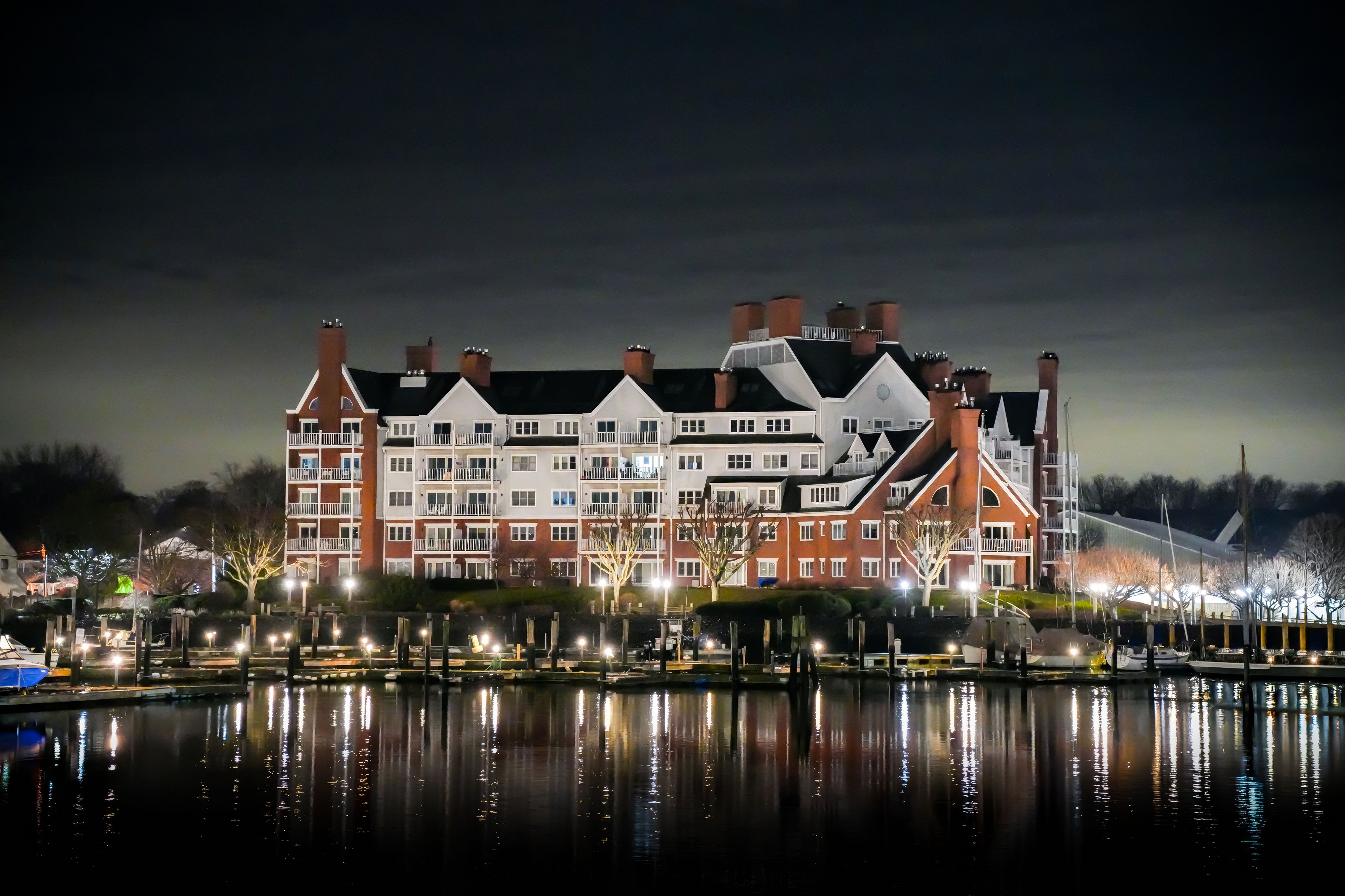 Illuminated Building by the Waterfront at Night · Free Stock Photo