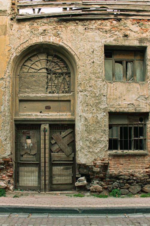 Free Crumbling facade of an old, abandoned building showing weathered textures and age. Stock Photo