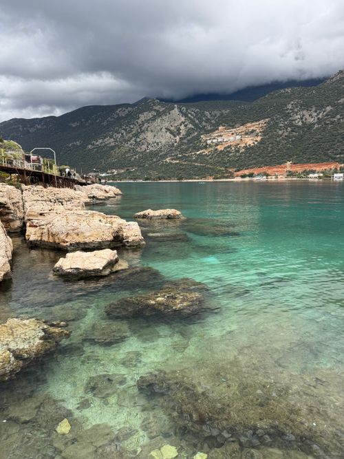 Free Scenic view of the turquoise coastline with rocky formations in Kas, Turkey. Perfect for travel inspiration. Stock Photo