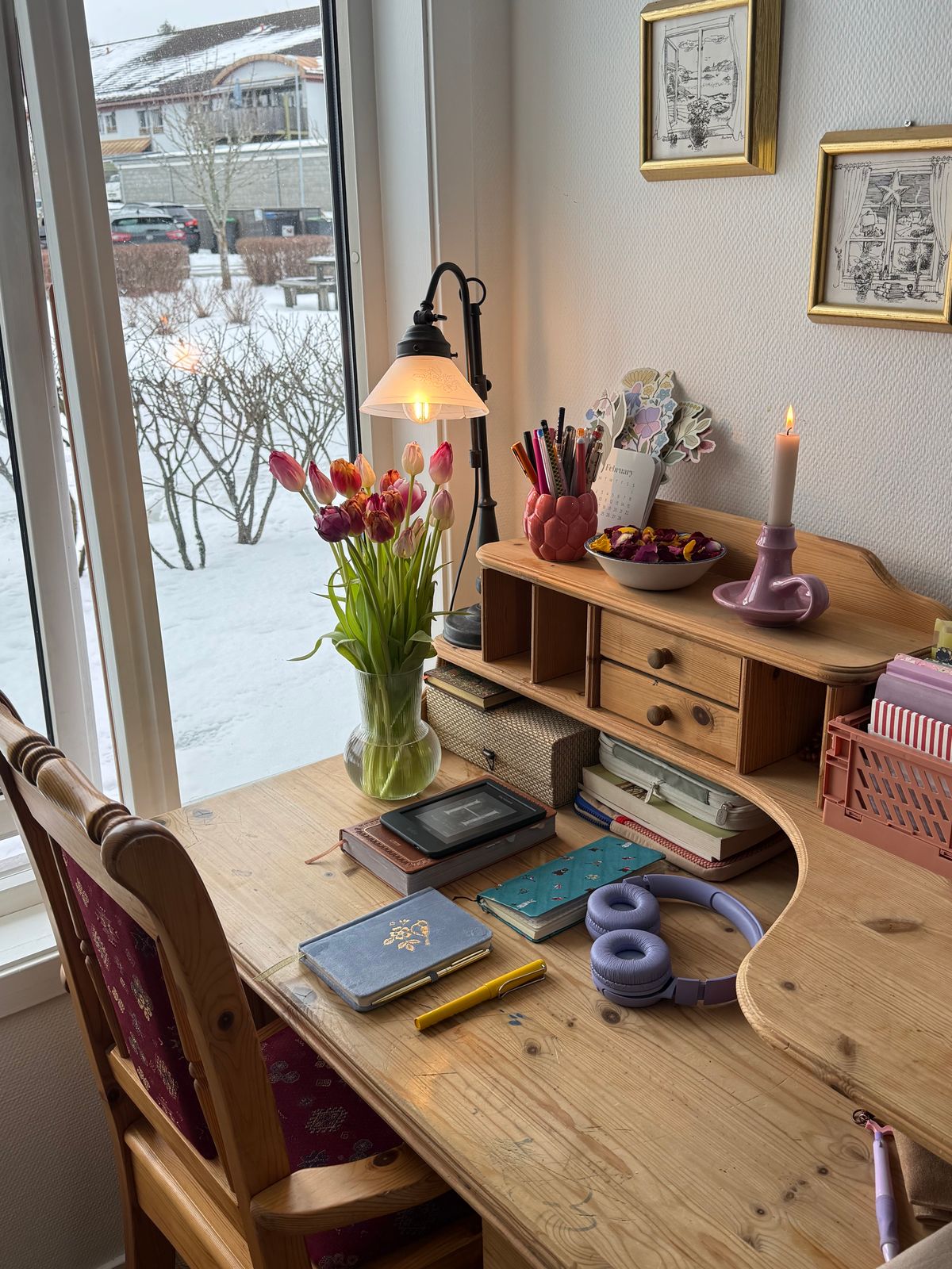 Cozy writing desk with flowers and a lamp