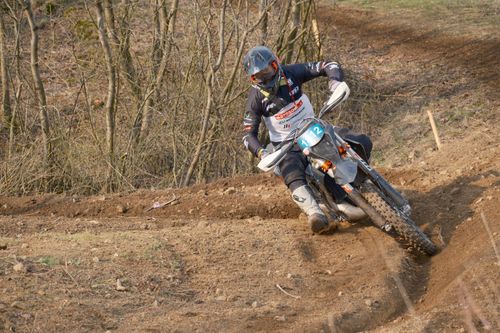Free Exciting dirt bike race scene capturing high-speed action in a forest trail setting. Stock Photo
