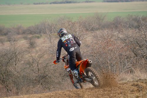 Free Dynamic motocross rider on a dirt bike navigating a rugged terrain in Jihomoravský kraj, Czech Republic. Stock Photo