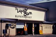 Front view of the Liquor Barn Supermarket in Cairns, Queensland, Australia. Outdoor signage and sunny weather.