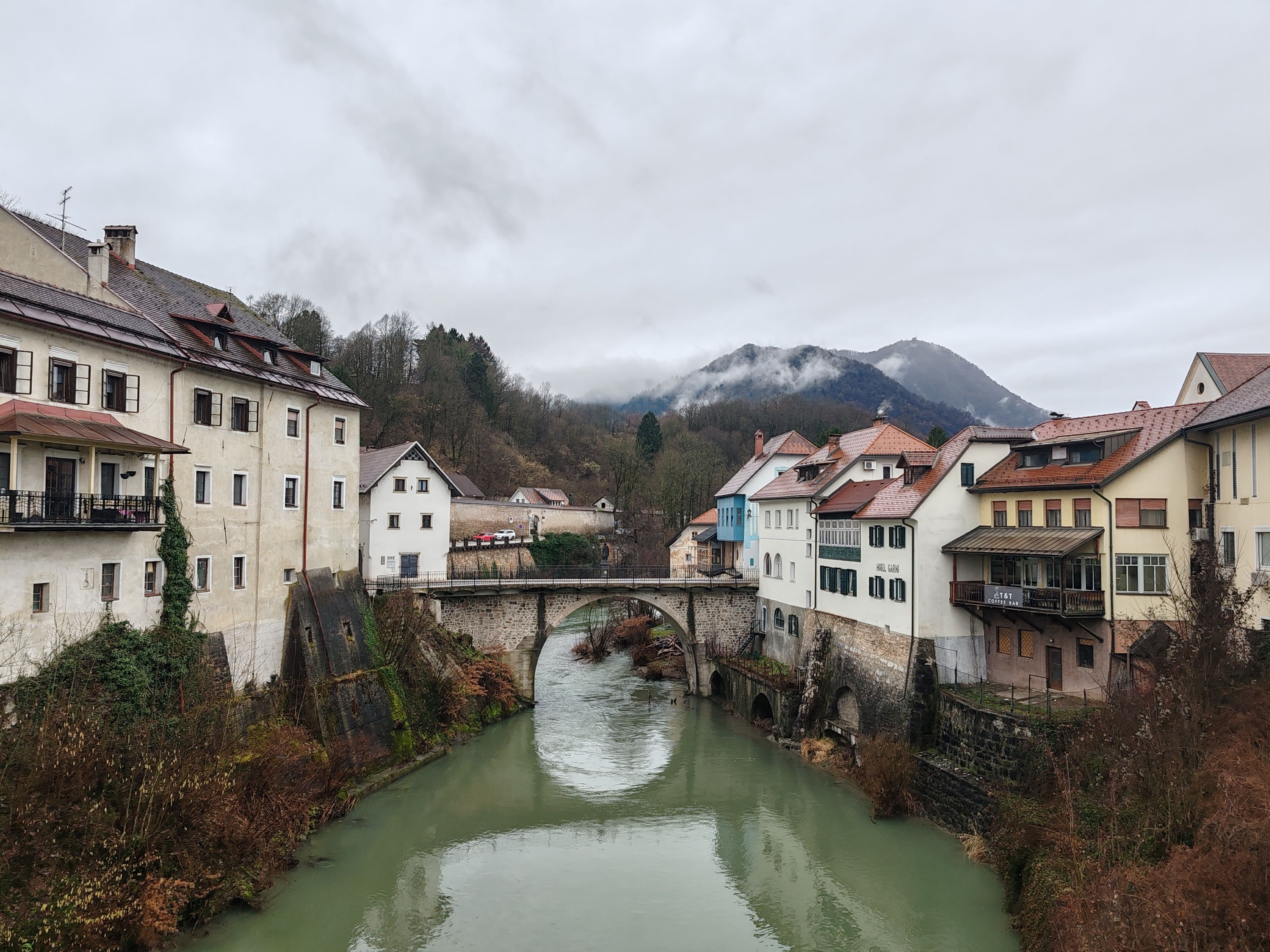 Charming Riverside Village with Stone Bridge · Free Stock Photo