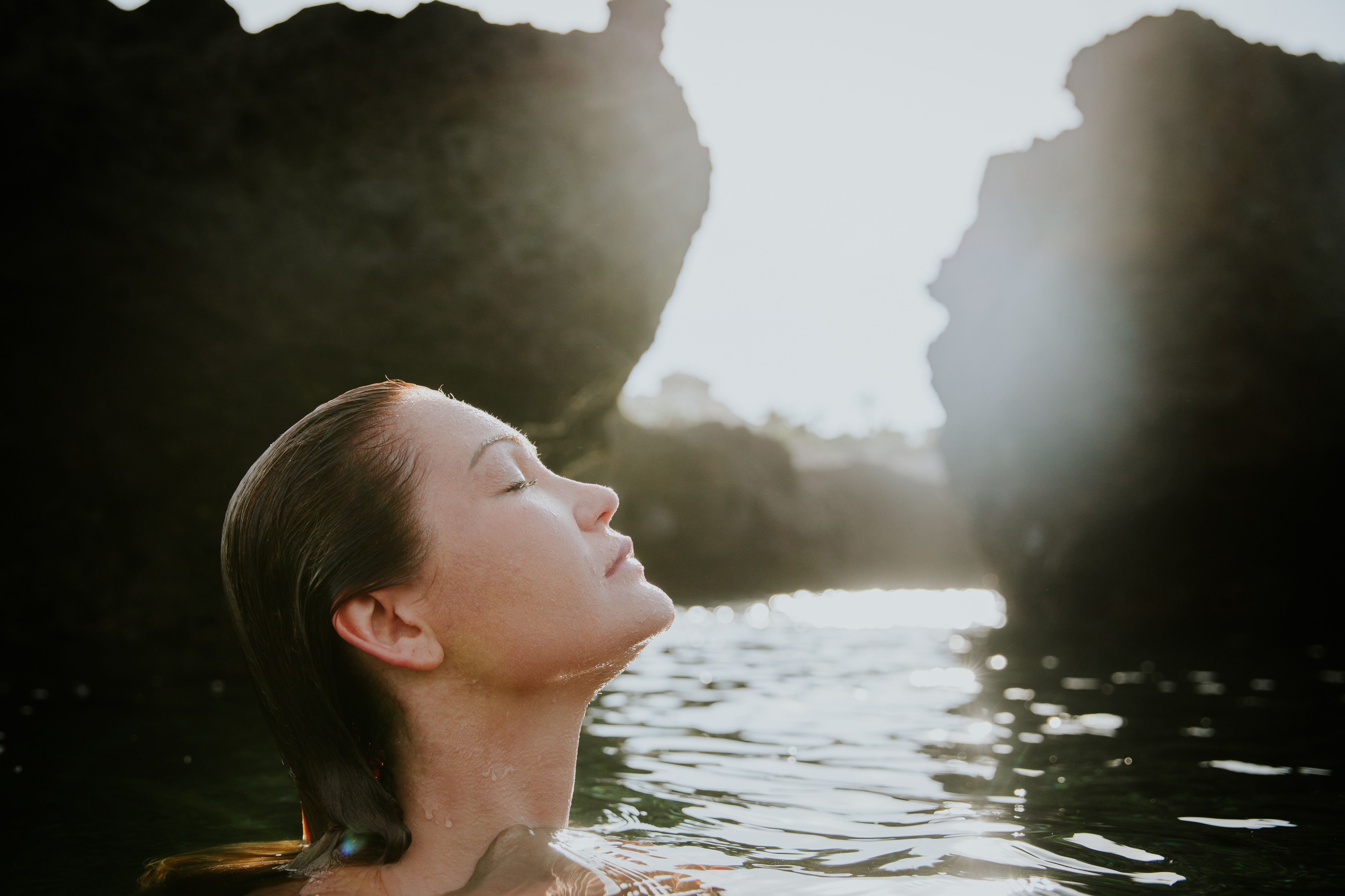 A woman enjoying a peaceful moment in the natural waters of the Canary Islands.