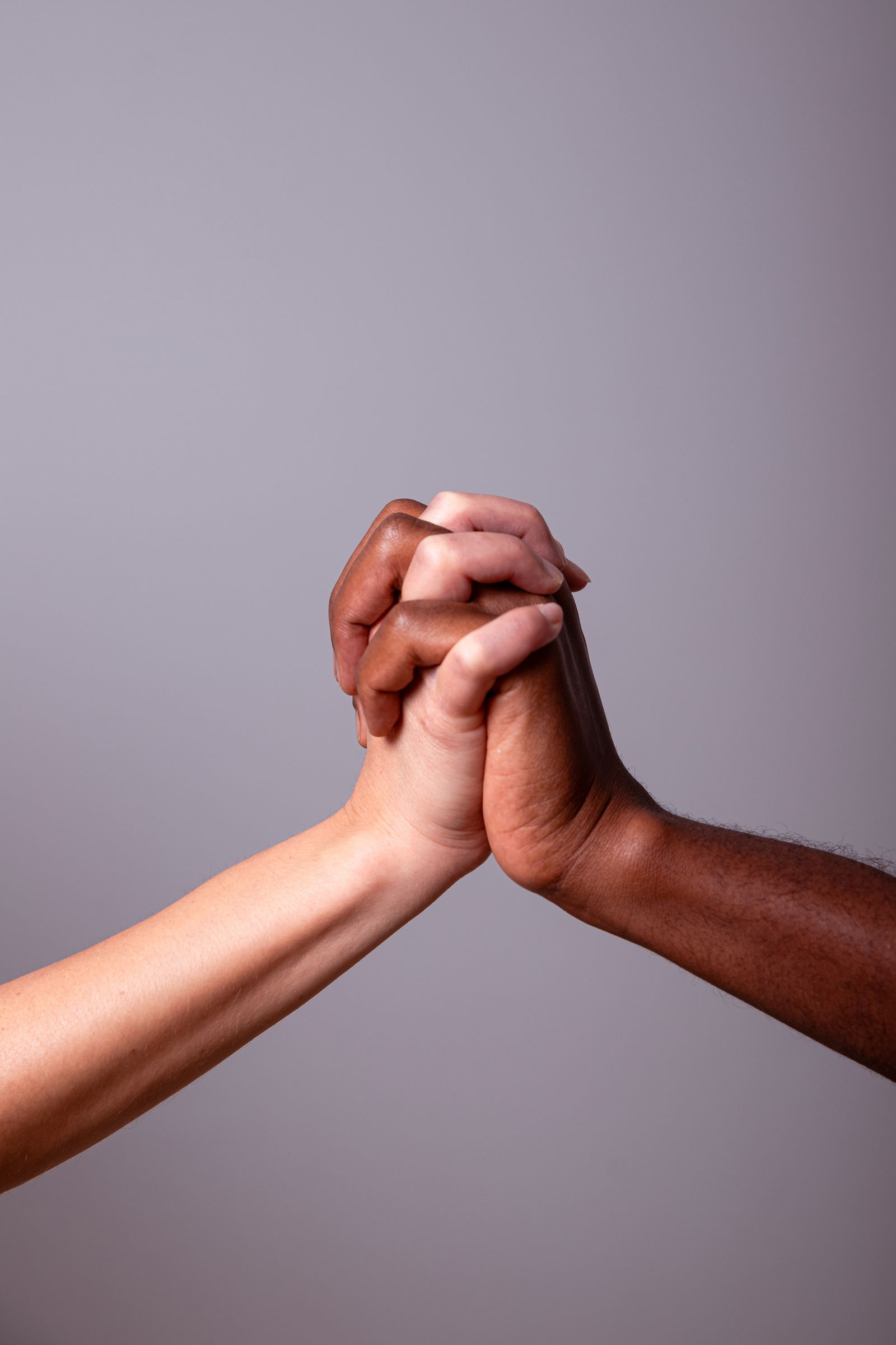 Two hands clasped in unity