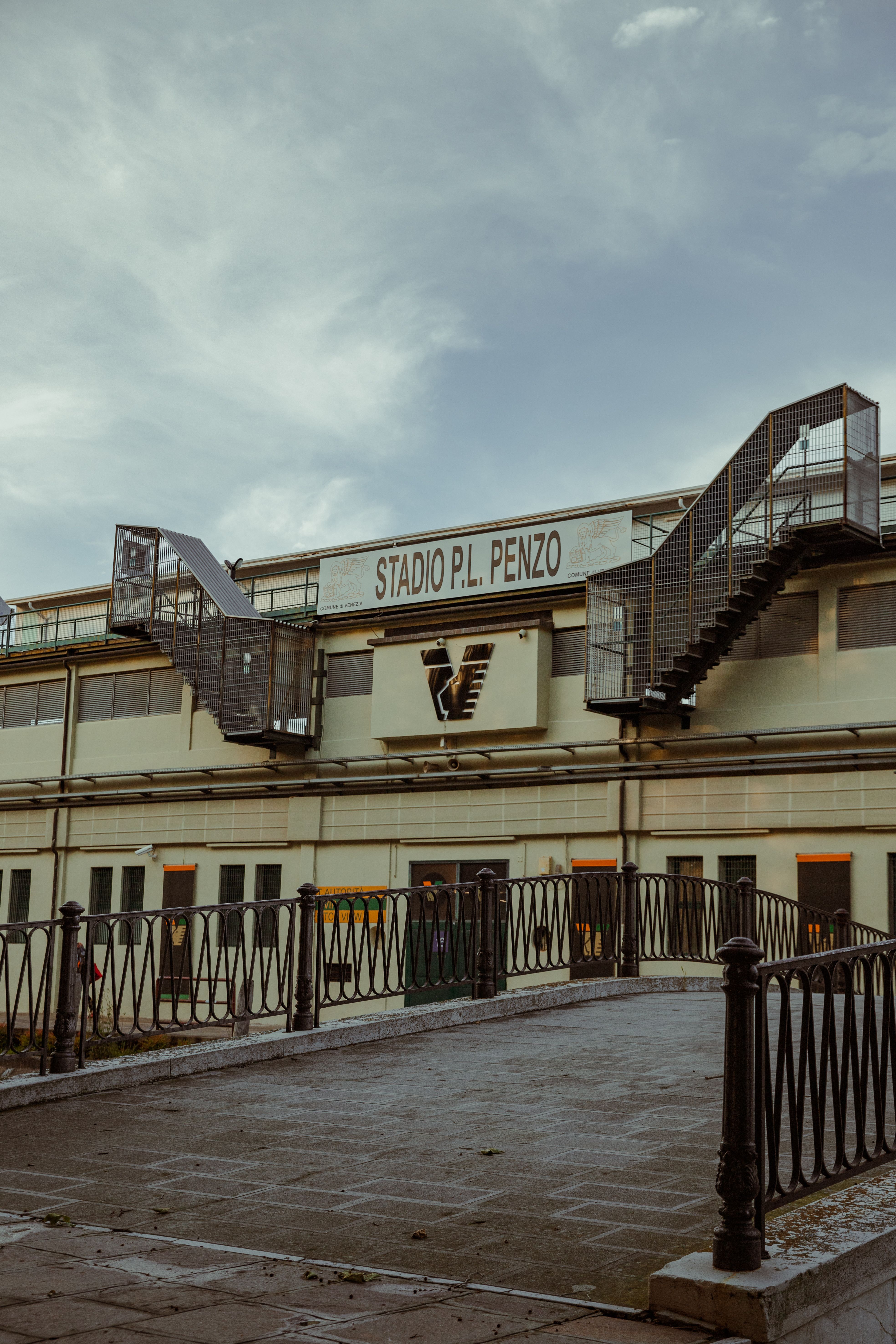 Exterior view of Stadio Pier Luigi Penzo in Venice, Italy featuring staircases and cloudy skies.