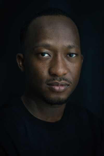 Portrait of a man on a dark background — photo by Travel with Lenses on Pexels