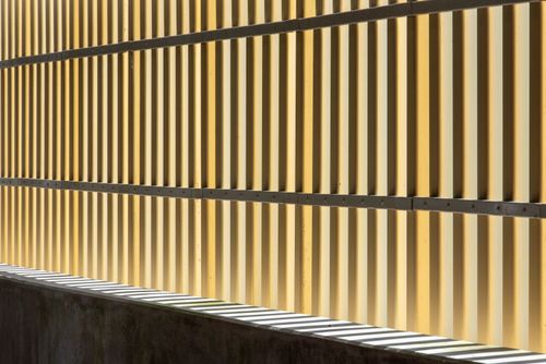 Free Close-up of a textured wall with sunlight casting shadows, creating a modern pattern. Stock Photo