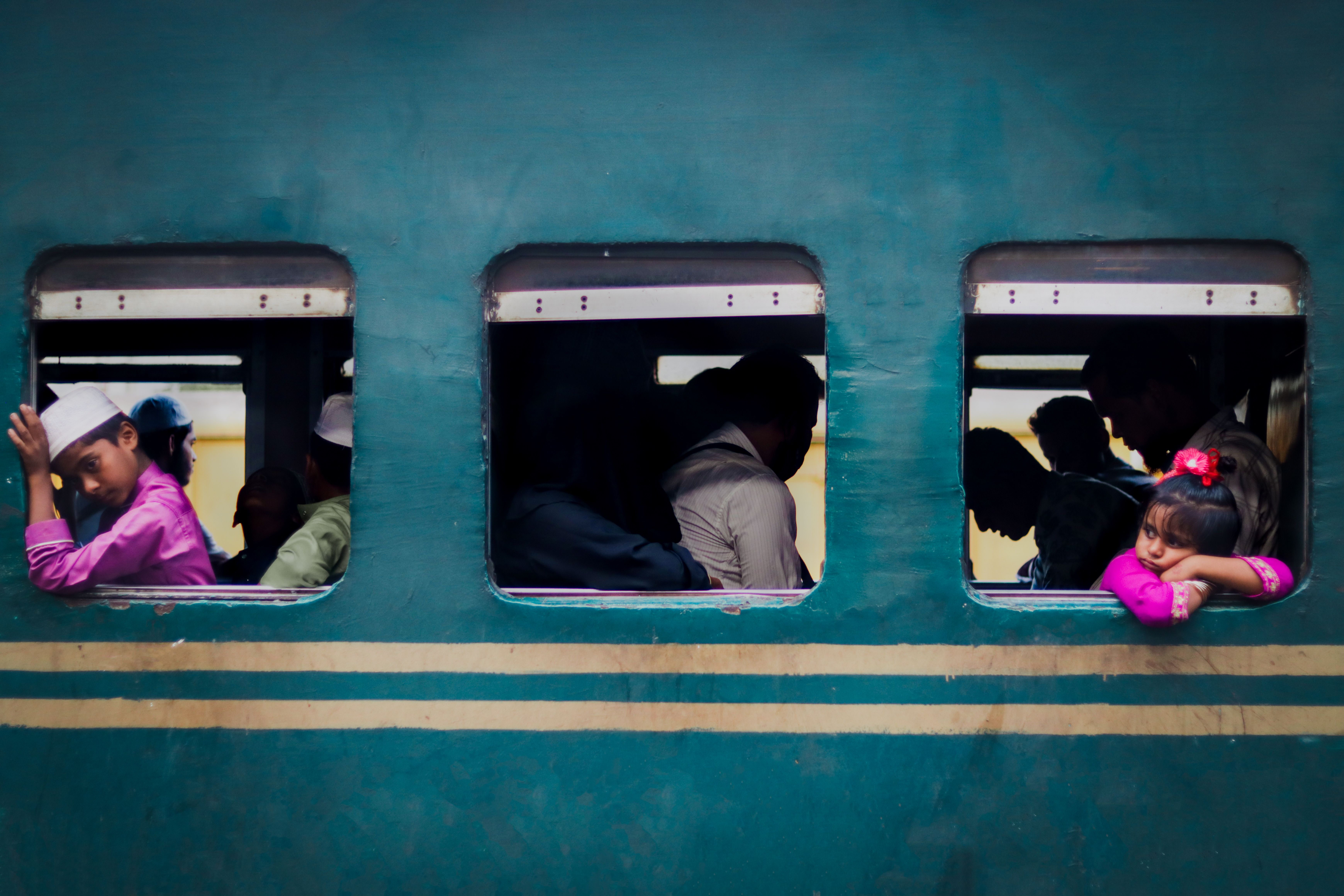 Captivating candid moment capturing daily train commute in Dhaka, Bangladesh, with vibrant colors and human connection.