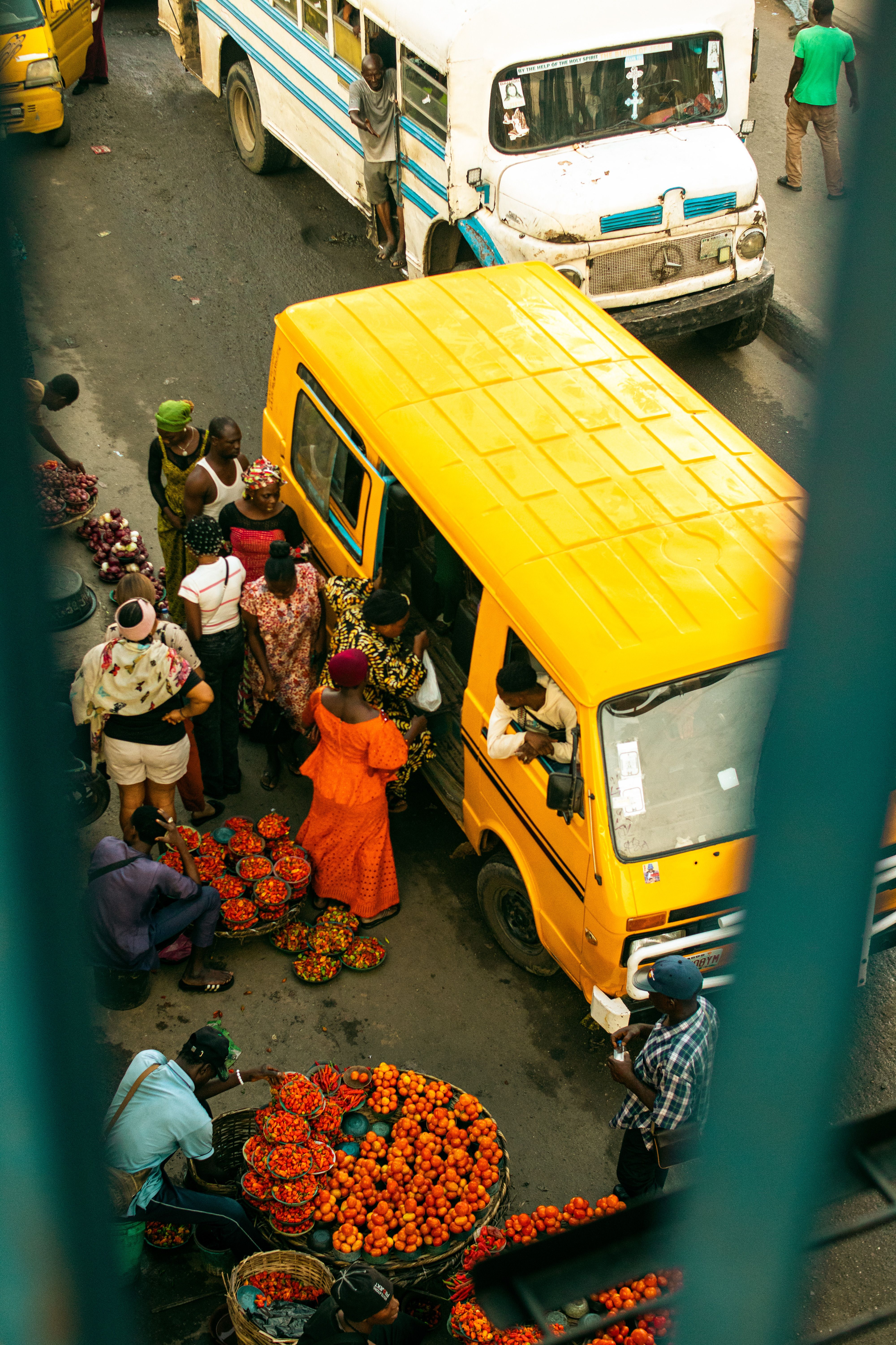 A vibrant market scene captured from above in Lagos, showcasing people and local produce.