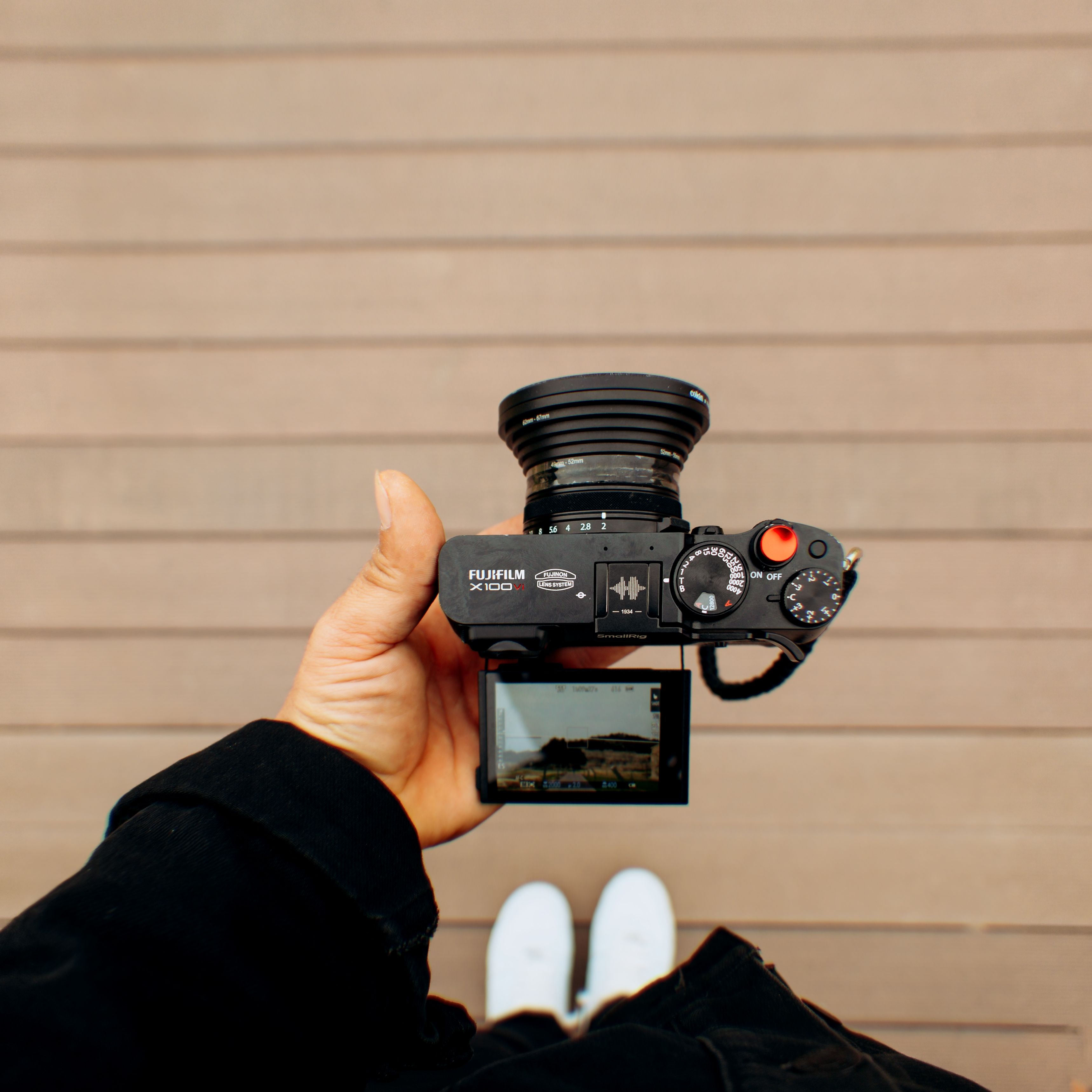 Person Holding Camera Overhead for Photography · Free Stock Photo