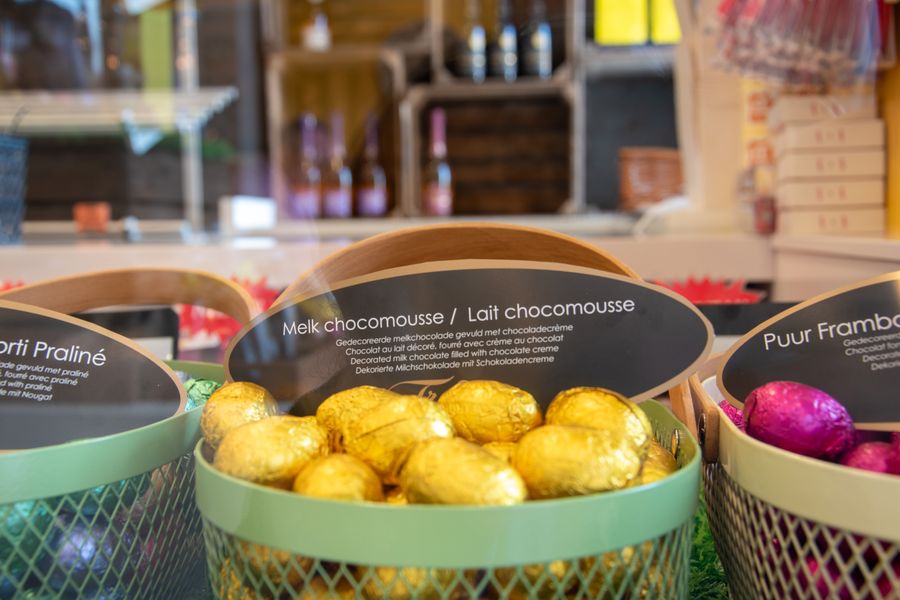 Decorative display of assorted Belgian chocolate eggs in a confectionary shop.