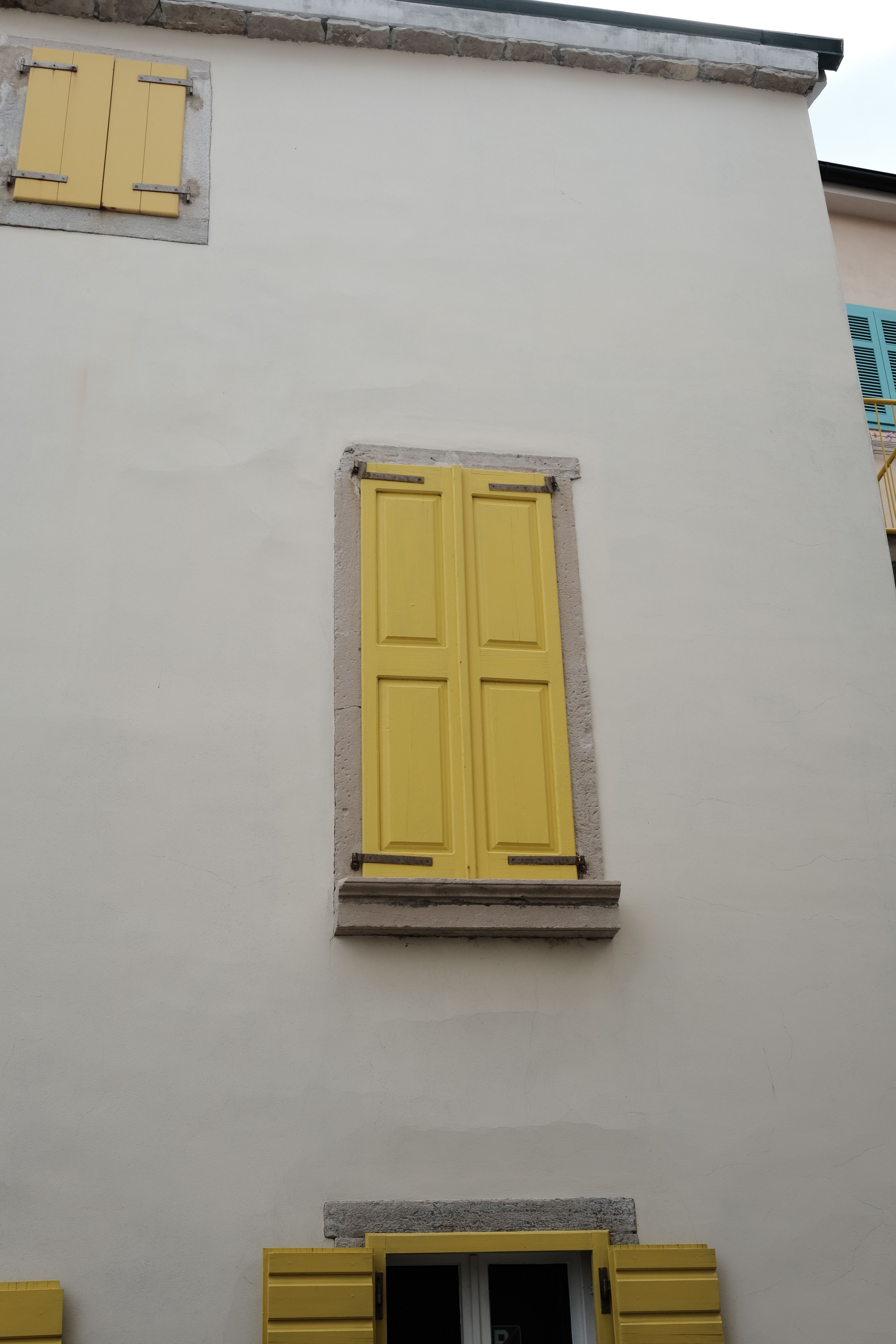 Charming Yellow Shuttered Window on White Stucco Building · Free Stock ...