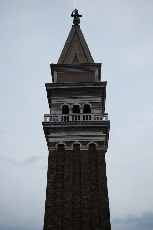 Free A striking view of St Mark's Campanile in Venice, soaring into a cloudy sky. Stock Photo