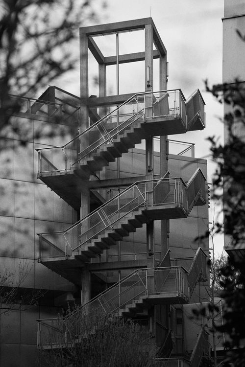Free Black and white image of an external metal staircase on a modern building, conveying urban architecture. Stock Photo