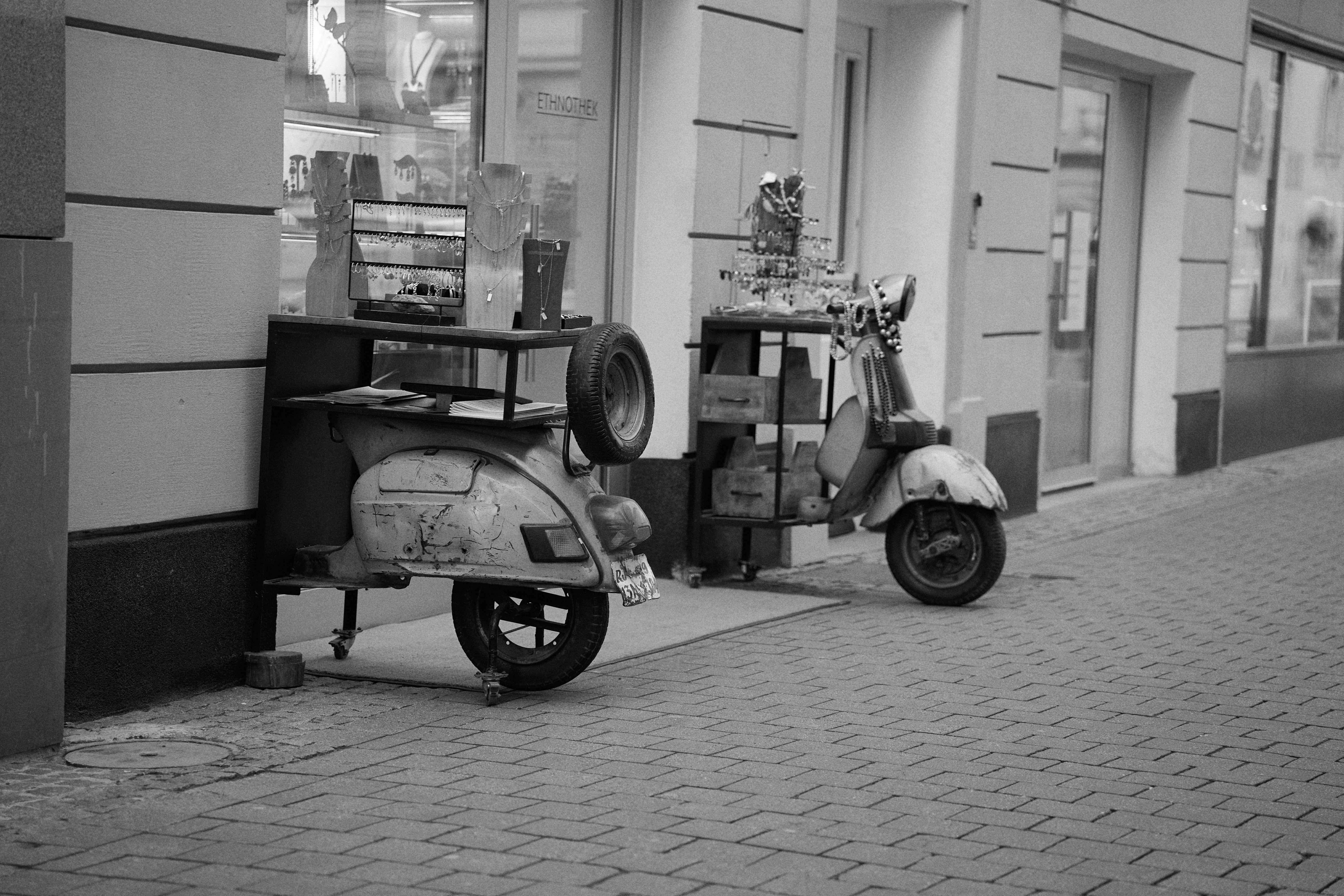Vintage Scooters Repurposed as Stylish Storefront Tables · Free Stock Photo