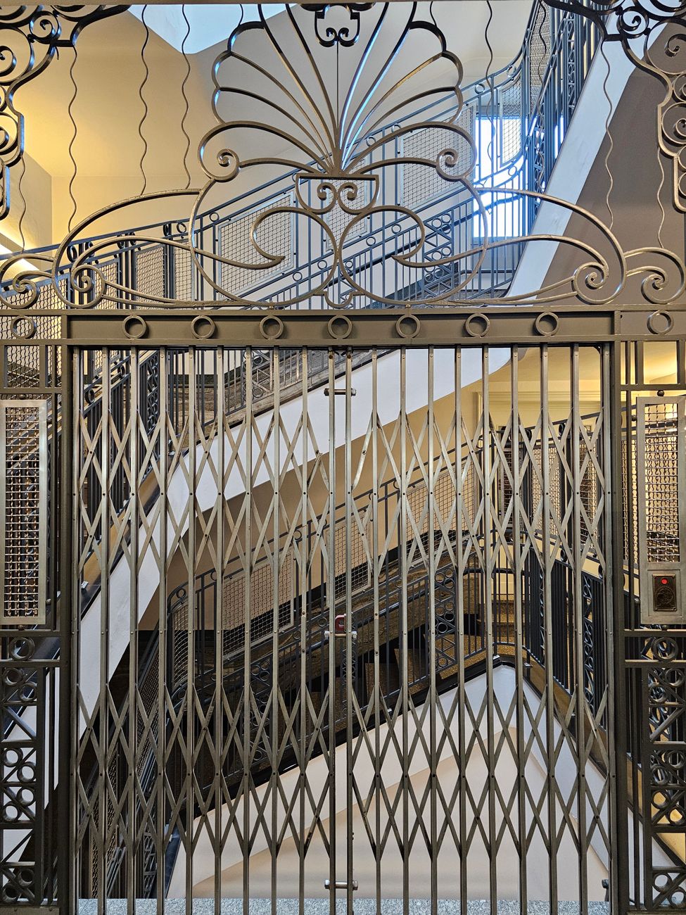 Intricate metal staircase design showcasing classic Art Deco architecture.. intricate, metal, staircase