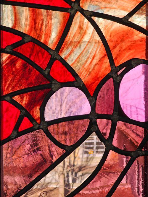 Free An intricate stained glass window featuring vivid colors and abstract patterns, capturing light beautifully. Stock Photo