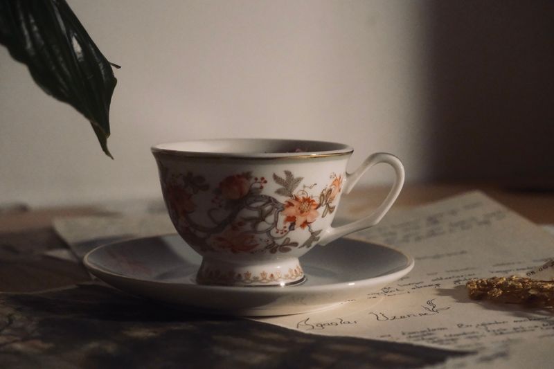 Vintage floral teacup and saucer on a rustic surface. Photo by Semanur Çoban on Pexels