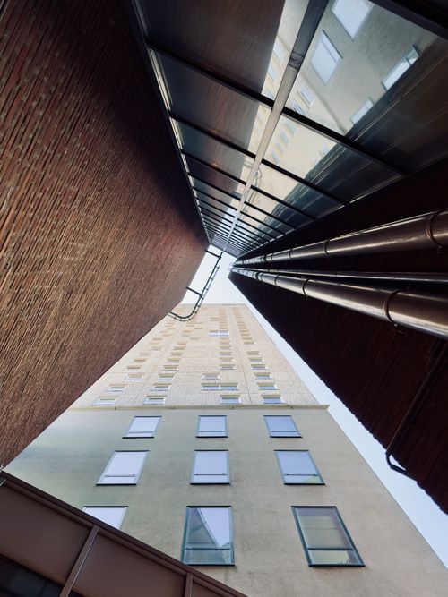Free Elevated view of modern architecture highlighting tall buildings with glass and brick elements. Stock Photo