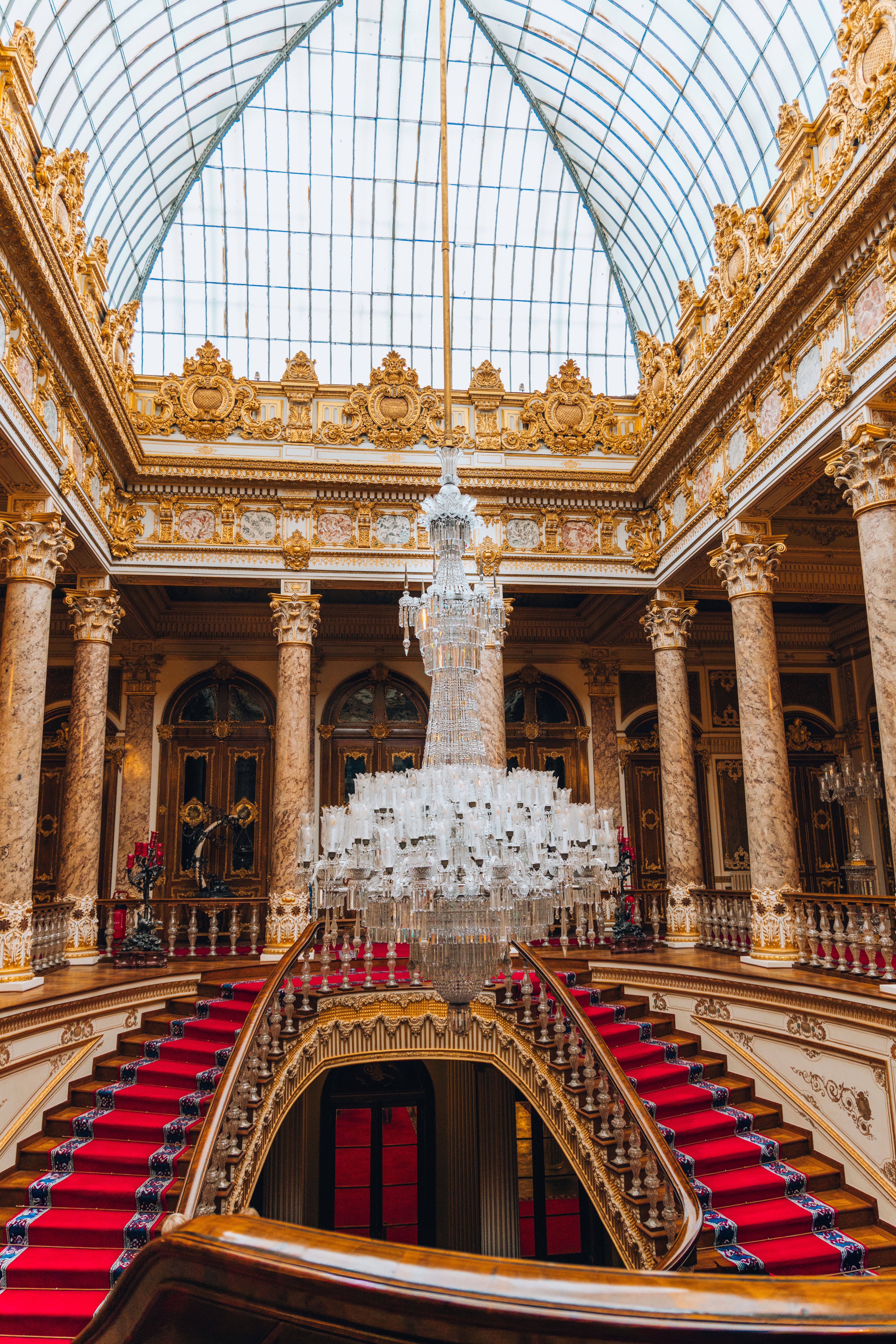 Ornate gilded interior of the Buckingham Palace State Rooms with chandeliers and decorative plasterwork in London