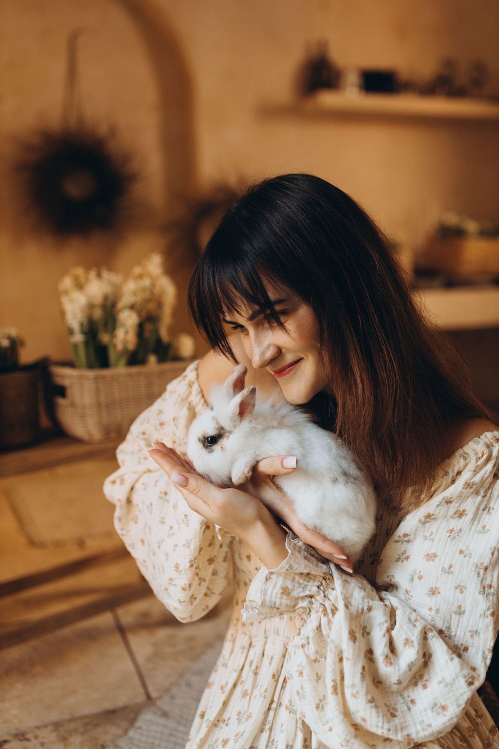 Woman Cuddling Cute White Rabbit Indoors · Free Stock Photo
