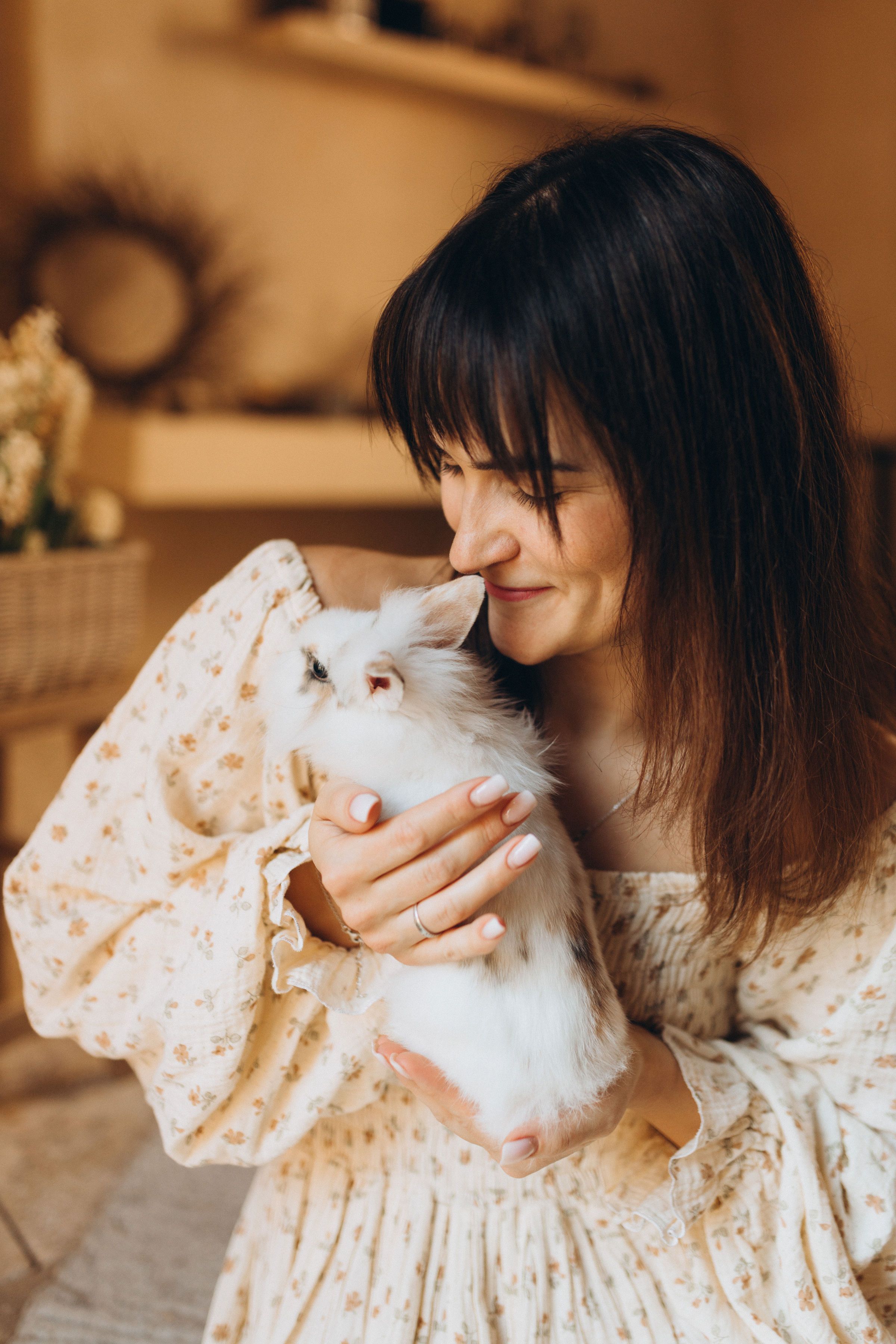 Young Woman Tenderly Holding a Fluffy Rabbit · Free Stock Photo