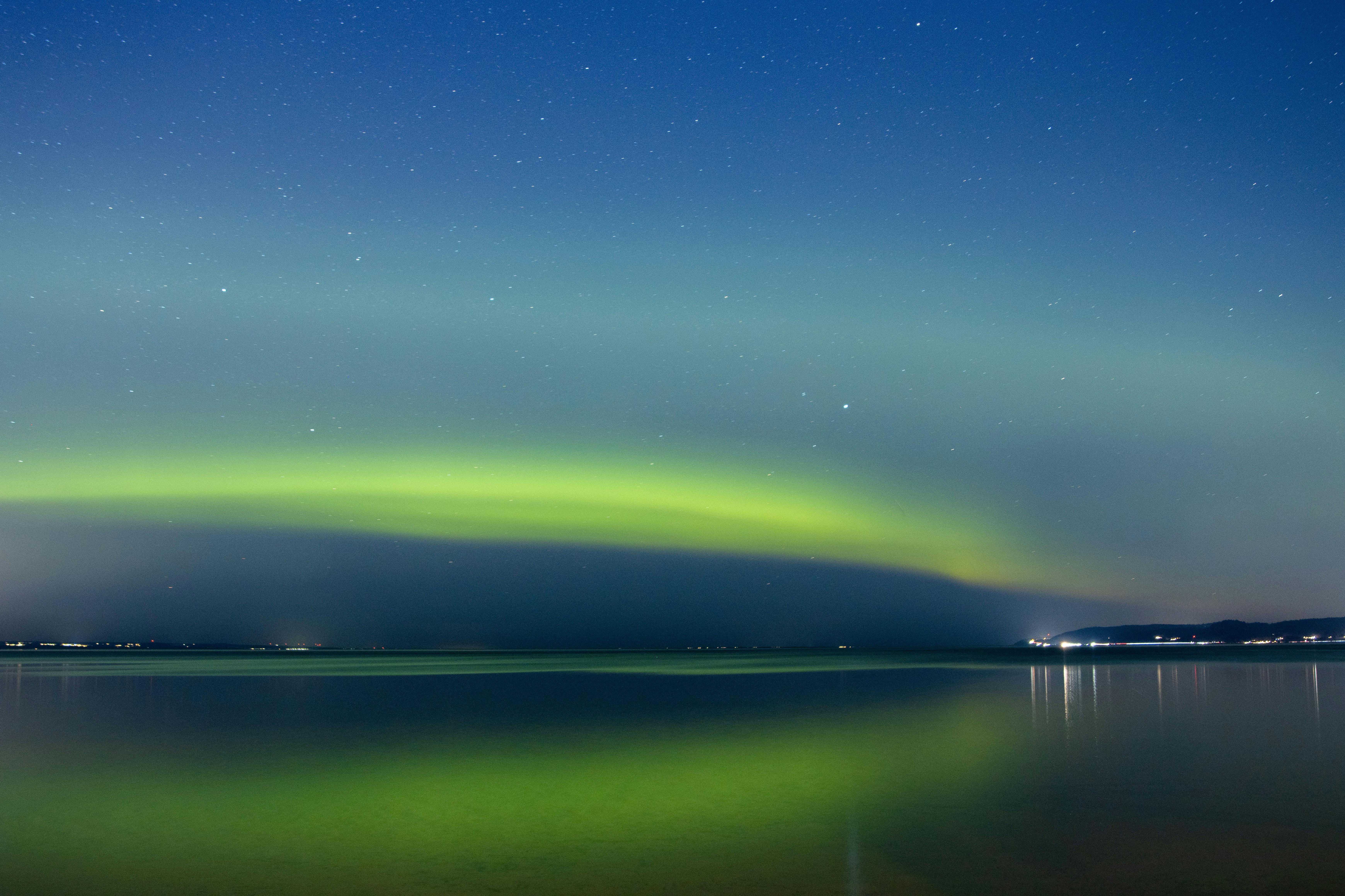 The Northern Lights glowing over a solo traveler in Iceland - safe countries to visit alone